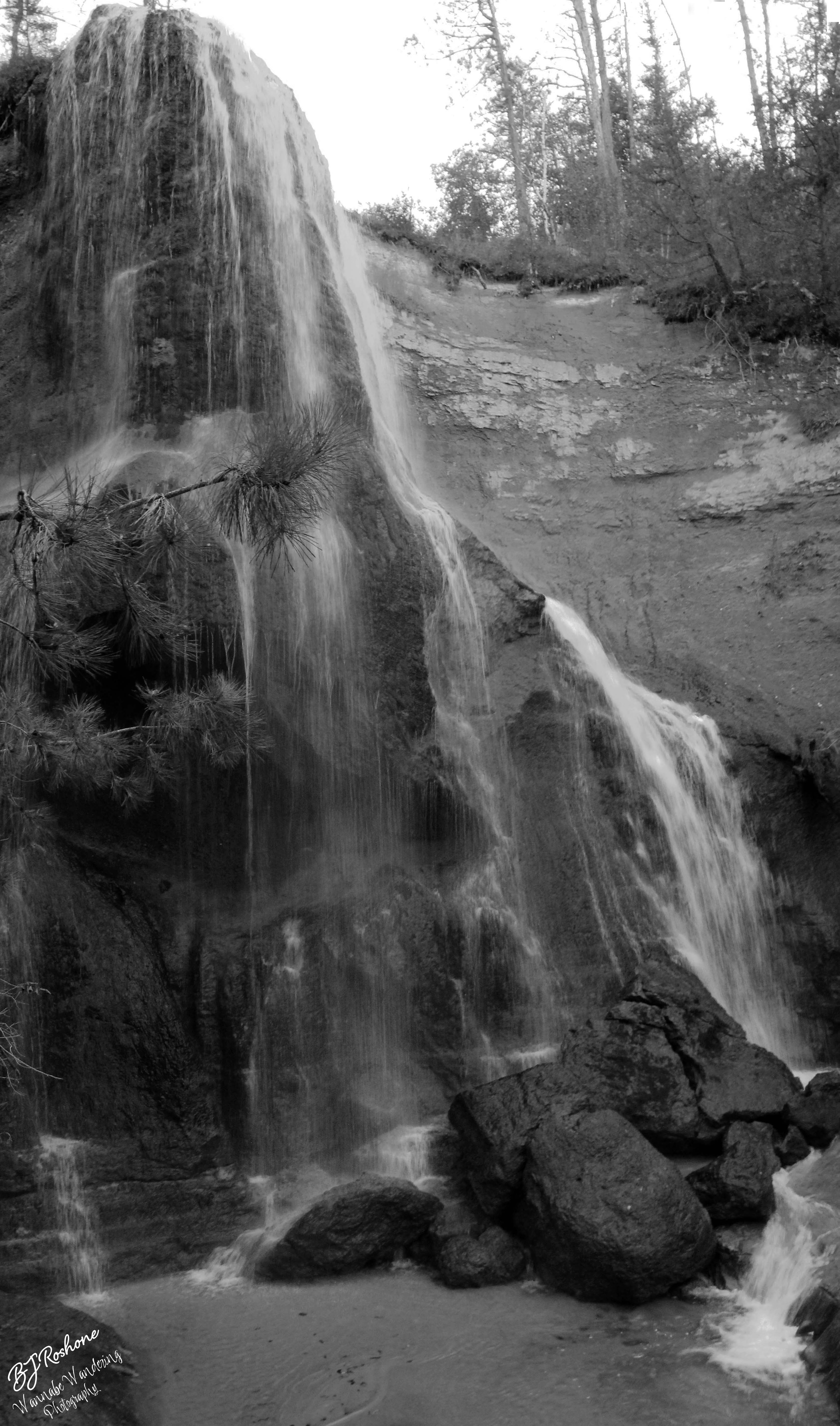 tall waterfall in black and white
