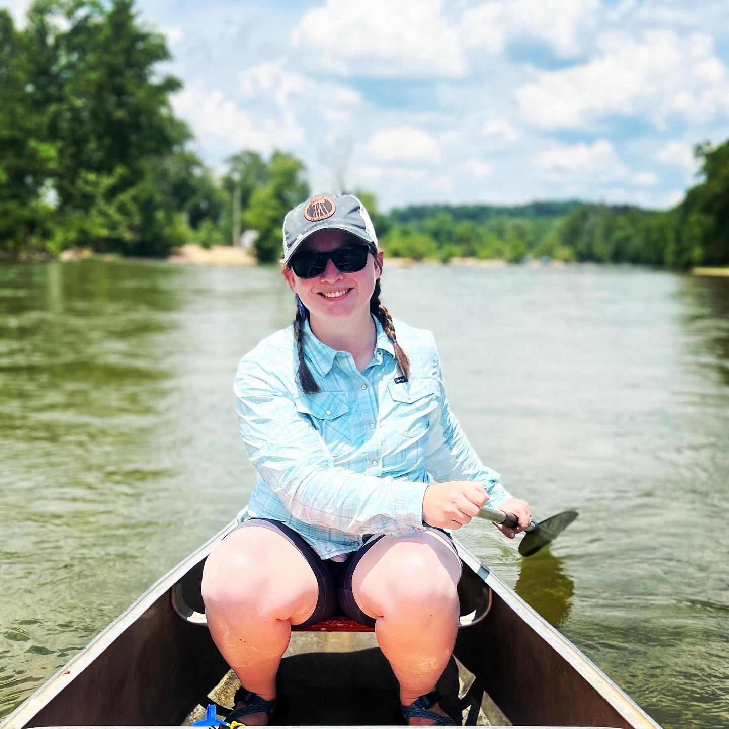 Woman in a canoe holding a paddle.